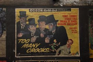 Vintage film poster for British comedy Too Many Crooks. Photo taken in a disused passageway of Notting Hill Gate station by Mike Ashworth of London Underground.