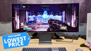 A photo of the Samsung Odyssey OLED G8 curved monitor, on a desk, with a game being played. There is a an image of a price tag in the bottom left highlighting that this monitor is on sale at its lowest ever price.