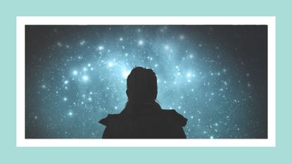 silhouette of a girl looking at the stars on a blue background