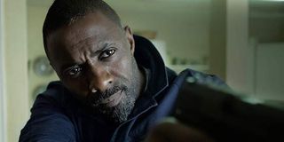 Idris Elba holding gun in Bastille Day