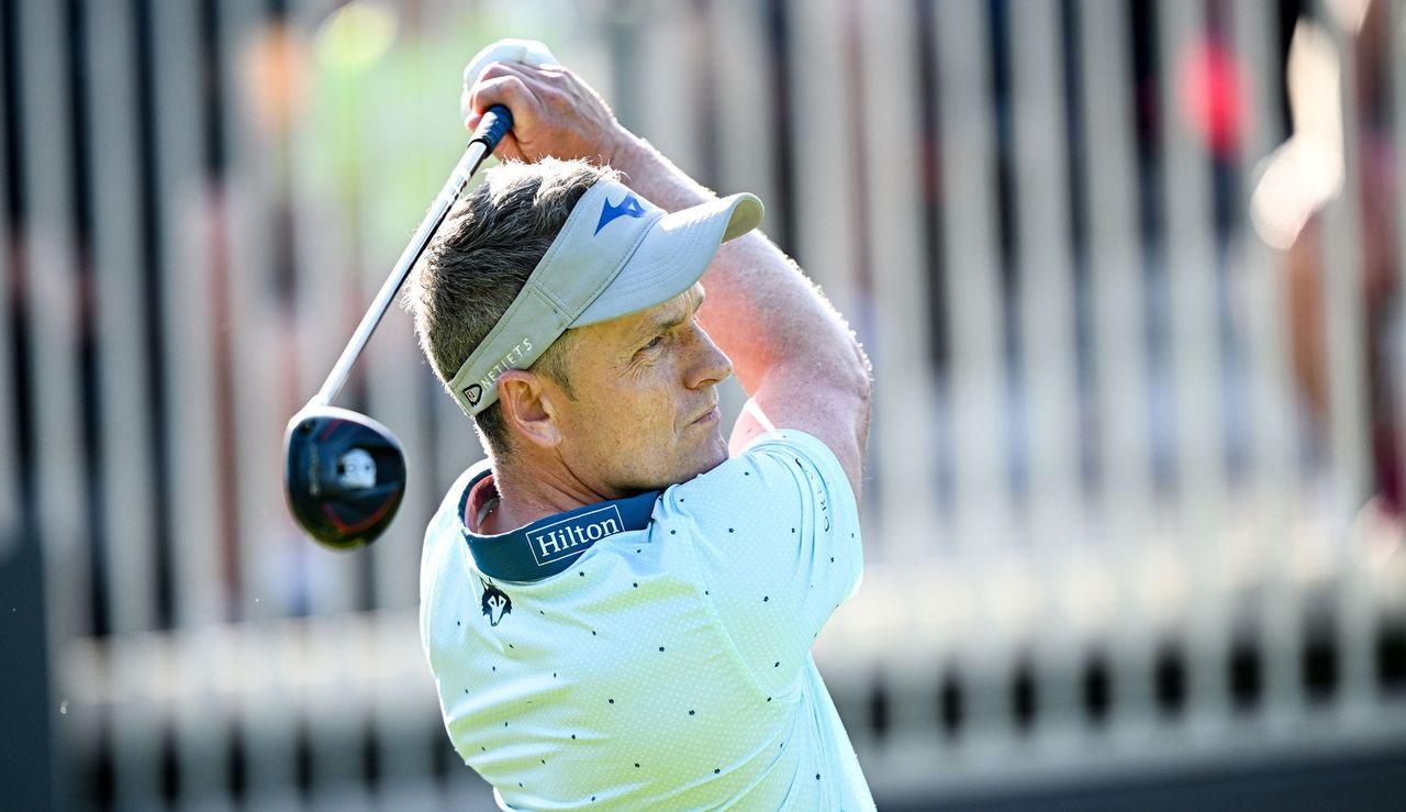 Luke Donald hits a fairway wood