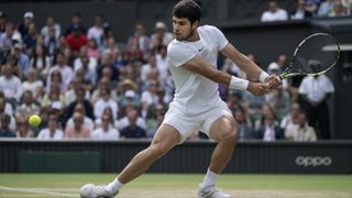 Carlos Alcaraz winds up a backhand return at Wimbledon