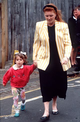 Princess Eugenie holds hands with mom Sarah Ferguson in June 1994, while wearing floral leggings and a pink sweatshirt, showing she's a royal style inspiration for Princess Lilibet