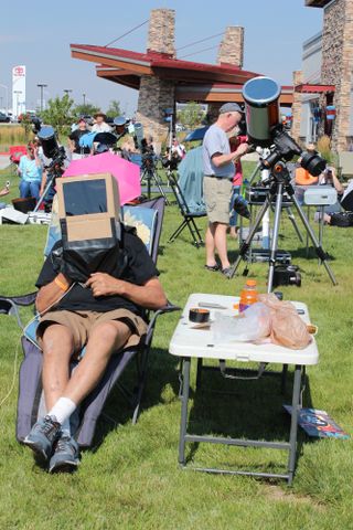 Unidentified "box boy" is ready for eclipse action at one of the total solar eclipse viewing sites in Casper, Wyoming. This observer donned a cardboard box with eye-protective plastic to view the partial eclipse before totality.