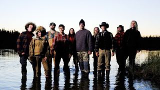 The cast of Alone season 10 stand in shallow water