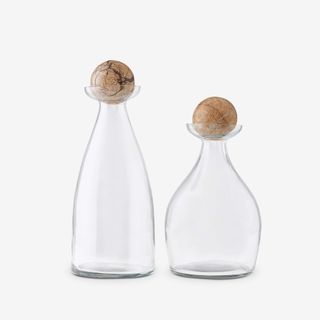 Two glass decanters with round marble toppers