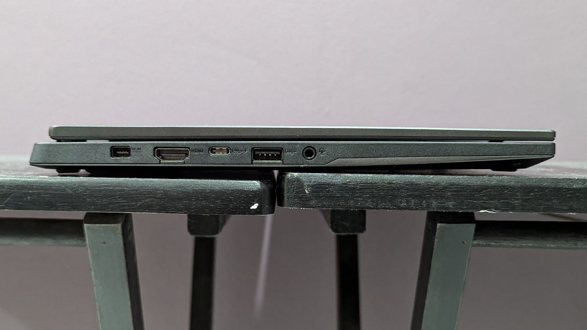 Side view of the Asus TUF Gaming A14 on a black desk showing the ports on the left side.