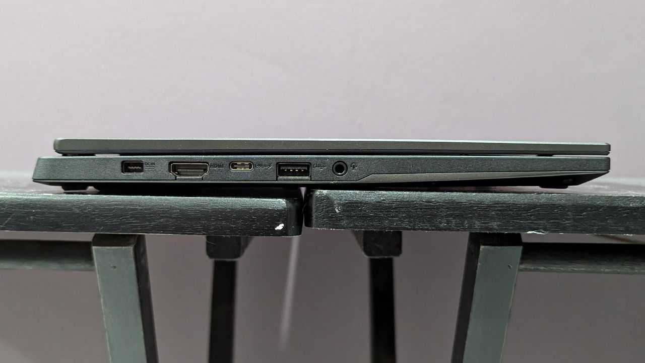 Side view of the Asus TUF Gaming A14 on a black desk showing the ports on the left side.