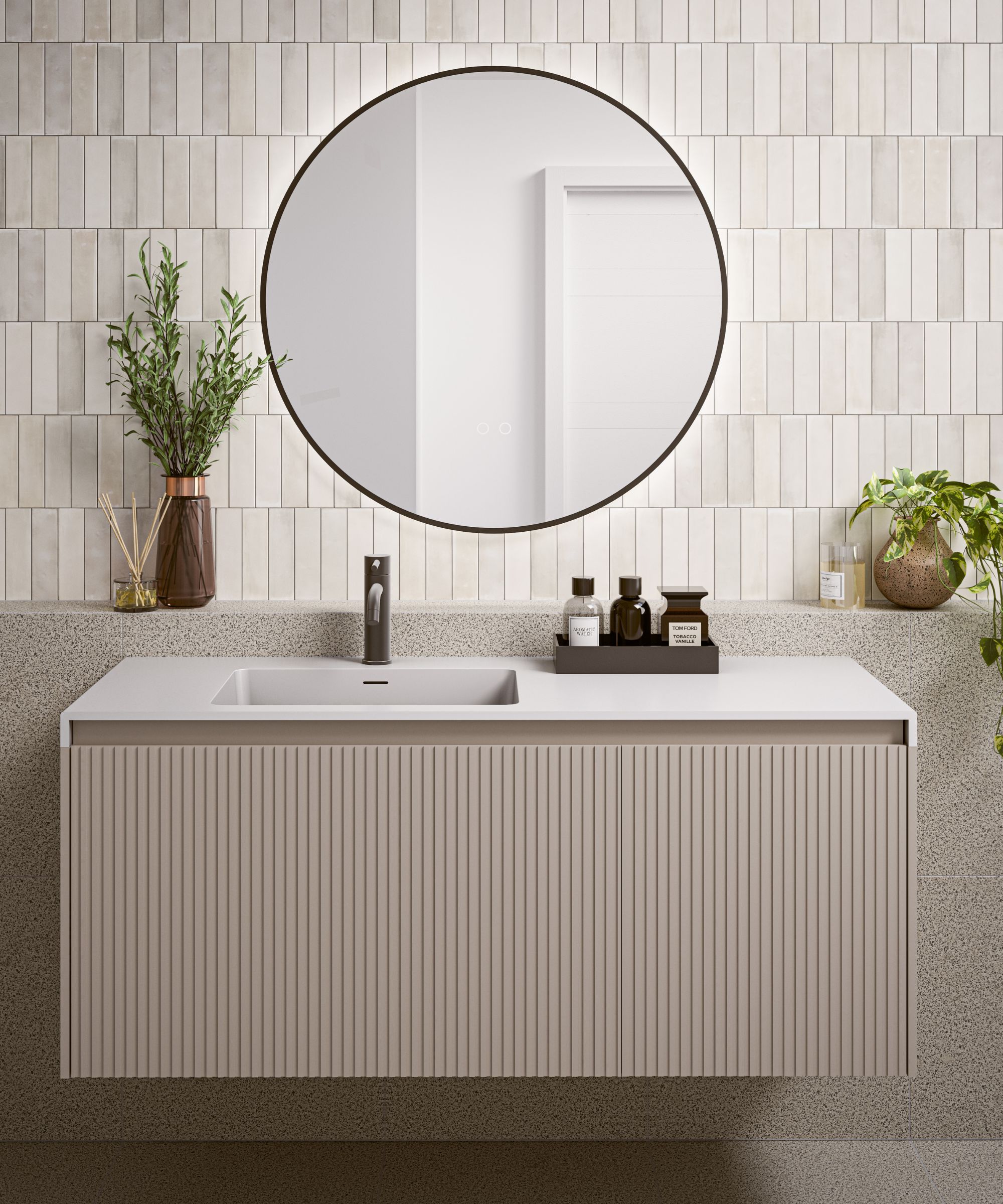 A warm neutral floating bathroom vanity with a tray filled with perfumes on the counter