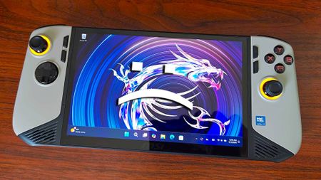 MSI Claw 8 AI+ handheld with Windows 11 desktop on screen and sad text face on top.