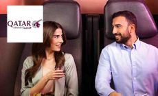 Qatar Airways logo placed over an image of a couple sitting in premium flight seats