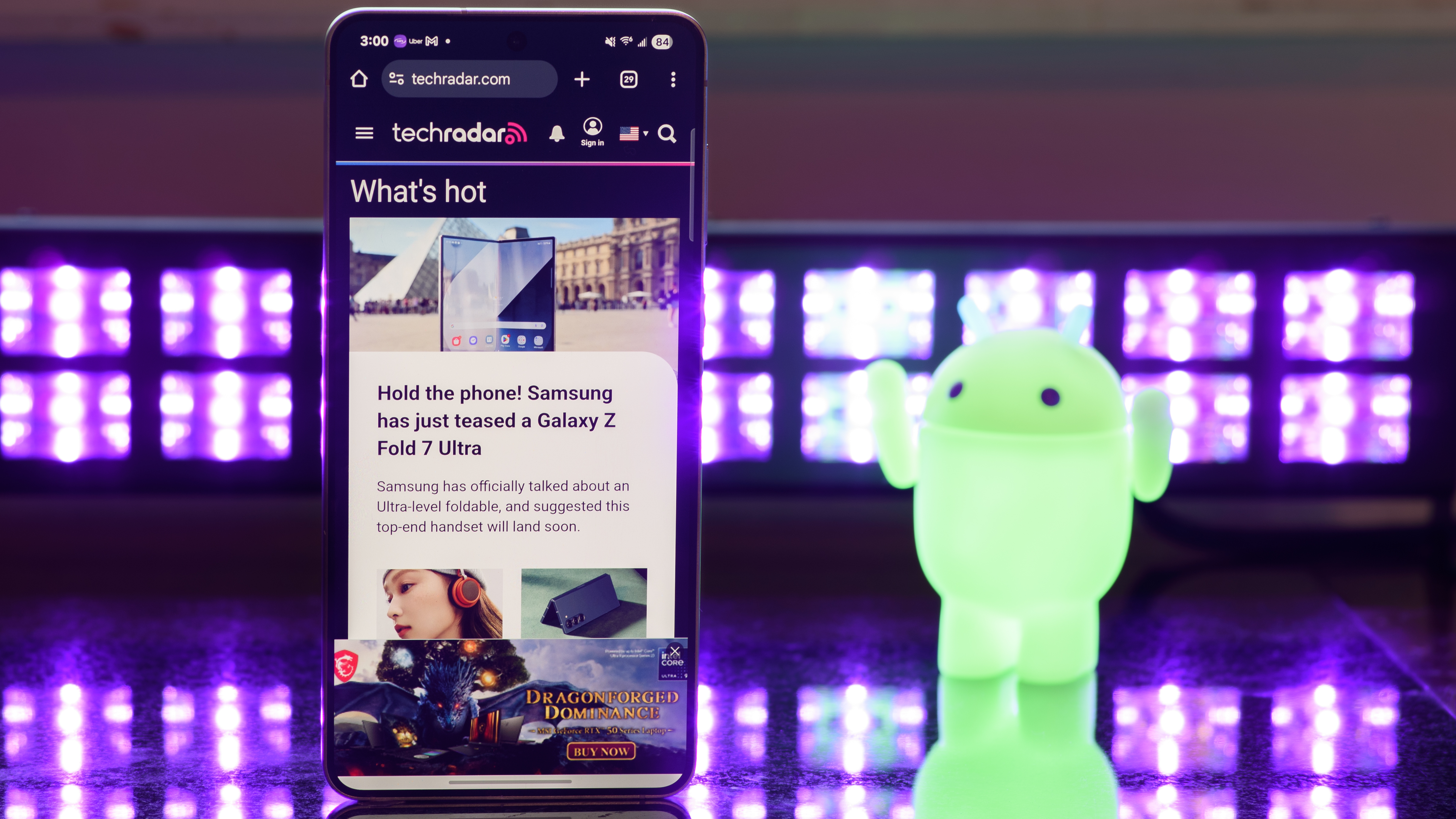 Samsung Galaxy S25 Edge showing TechRadar.com with black lights and an Android figuring blurred in the background