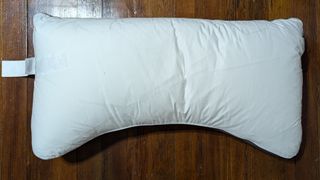 Sleep Number NaturalFit Ultimate Pillow on a brown wood floor