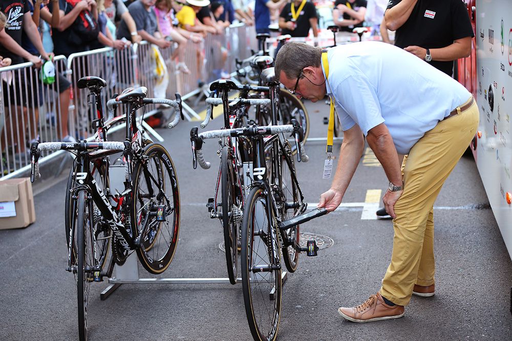 A UCI commissaire checks bikes at the Tour de France
