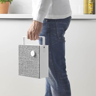 Person carrying portable Bluetooth speaker
