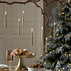 LED floating candles in gold dangling over a festive tablescape