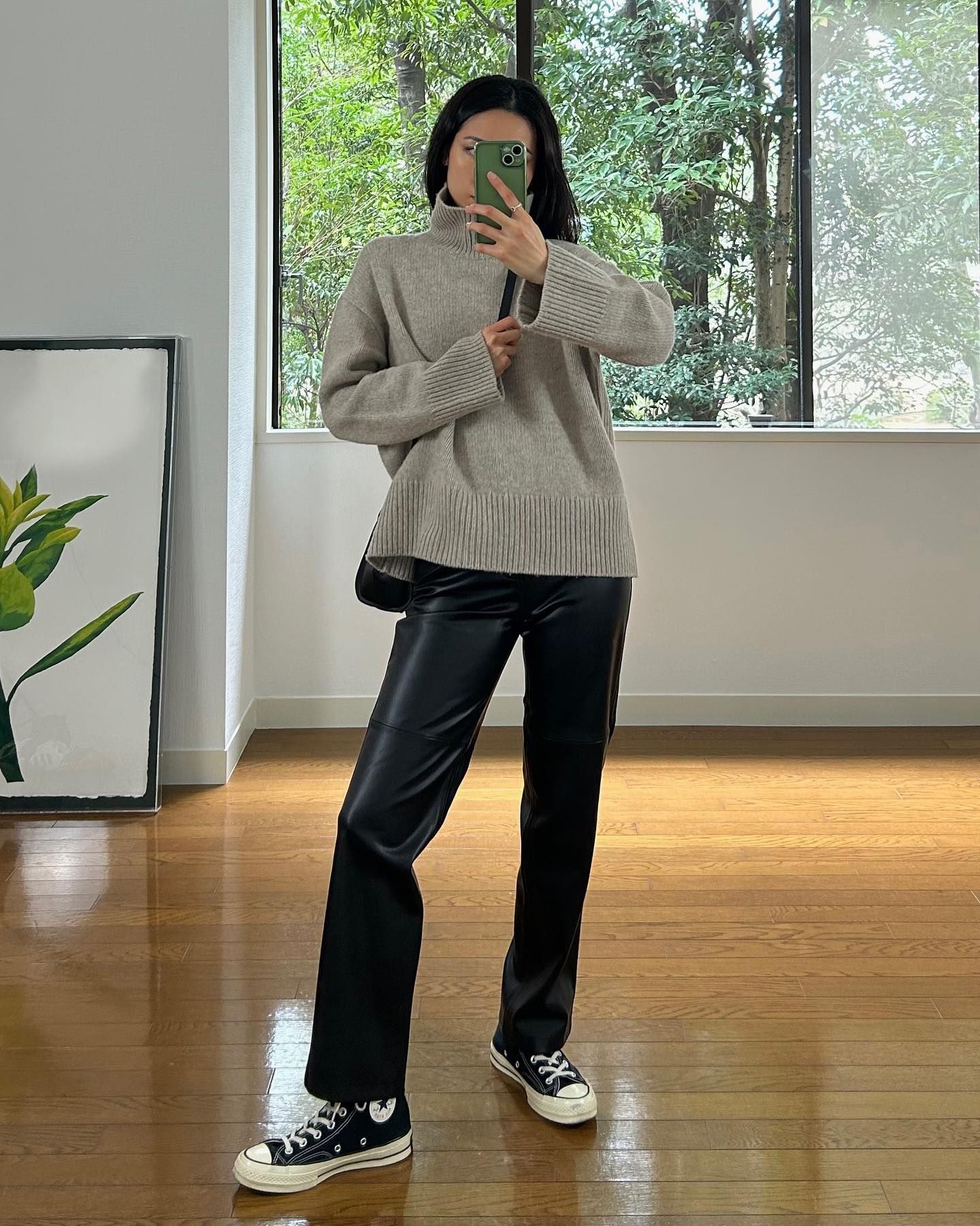 A woman wearing a fall leather-pant outfit in 2026.