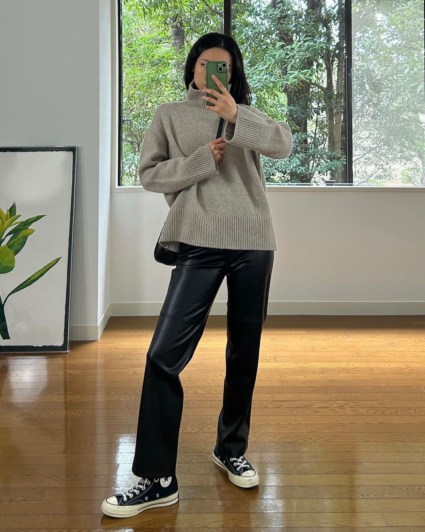A woman wearing a fall leather-pant outfit in 2026.