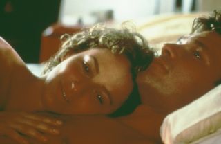 Jennifer Grey lies on Patrick Swayze's chest in a scene from Dirty Dancing