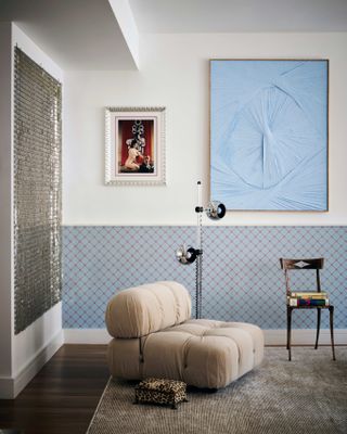 Living room with cream chair and blue artwork
