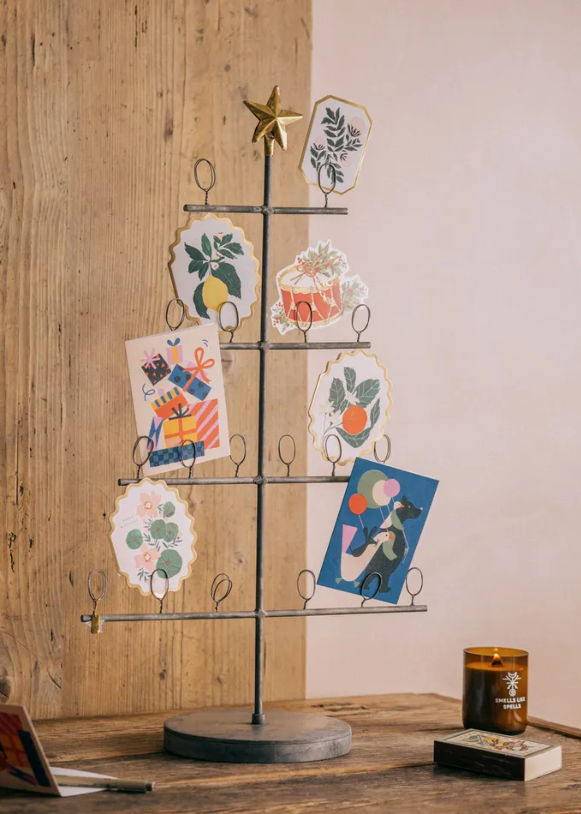 A metal Christmas tree card stand