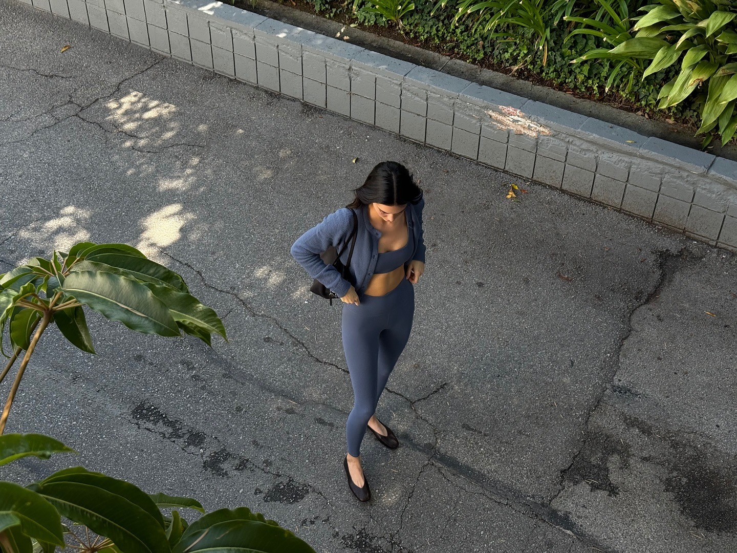 Kendall wears alo leggings, sport bra, jacket, and the row stella ballet flats.