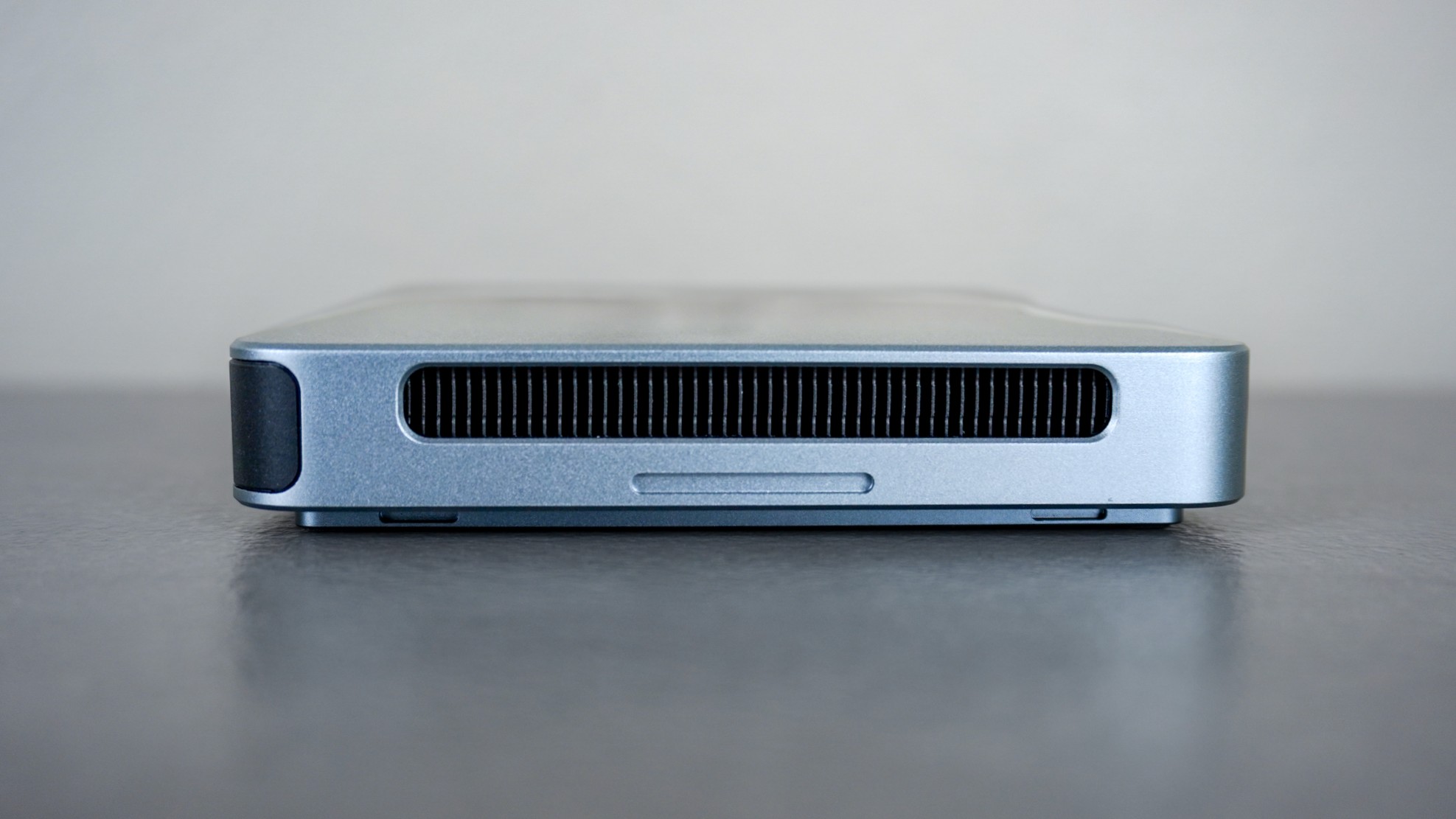 The Khadas Mind 2S on a desk showing the cooling vents on its sides