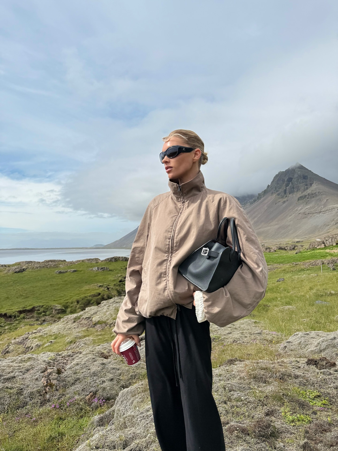 Elsa Hosk wearing a funnel-neck jacket and black pants in Iceland