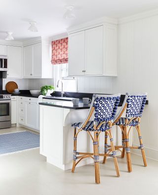 kitchen white units white walls blue pattened stools