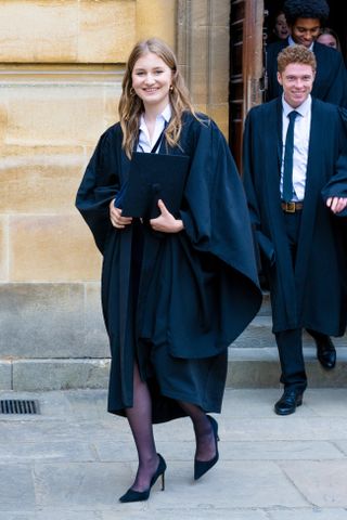 The Crown Princess Elisabeth wears a graduation gown with pumps after finishing her degree in History and Politics at Lincoln College, University of Oxford