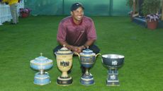 Tiger Woods poses with all four World Golf Championship trophies