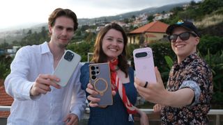Three people holding the best AI phones - Samsung Galaxy S25 Ultra, iPhone 16 Pro, Google Pixel 9 Pro