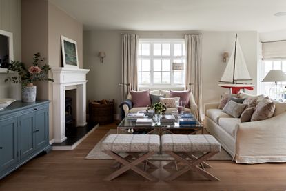 Cream sofas, blue cabinet, white fireplace