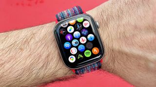 Close up of the Apple Watch 11 on a user's wrist with the app icon screen displayed