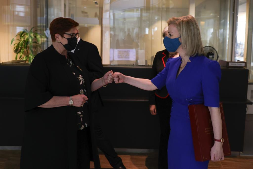 Marise Payne and Liz Truss greet each other