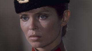 Barbara Bach stands stoically in her KGB uniform in The Spy Who Loved Me.