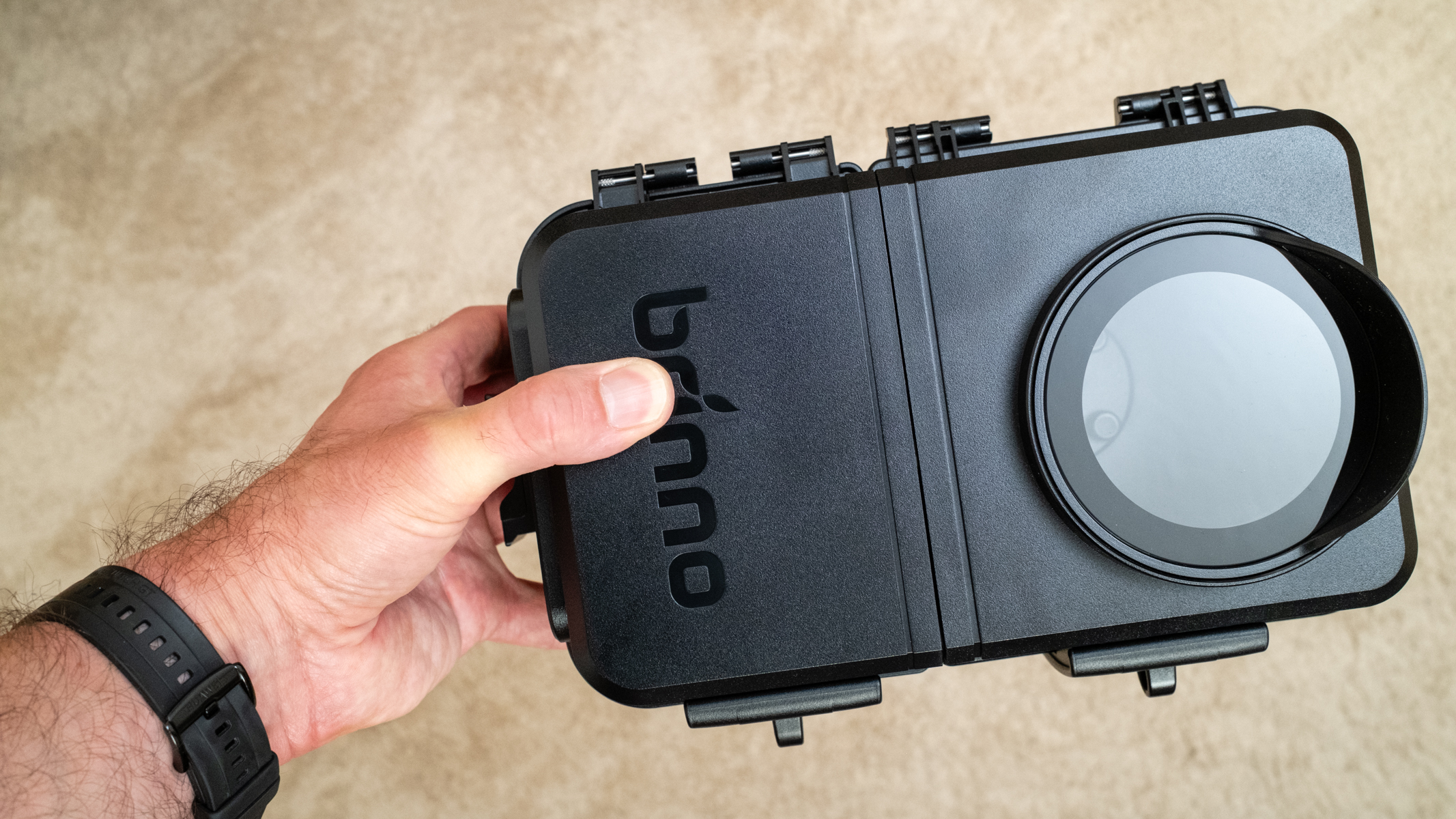 Brinno BCC5000 Time Lapse Bundle housing held in a man's hand for scale