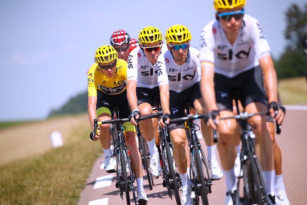 Chris Froome in yellow behind the Sky train.