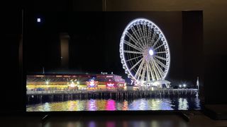 TCL QM851G TV showing image of Ferris wheel