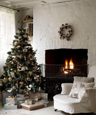 classic christmas tree decor in cozy living room with fire