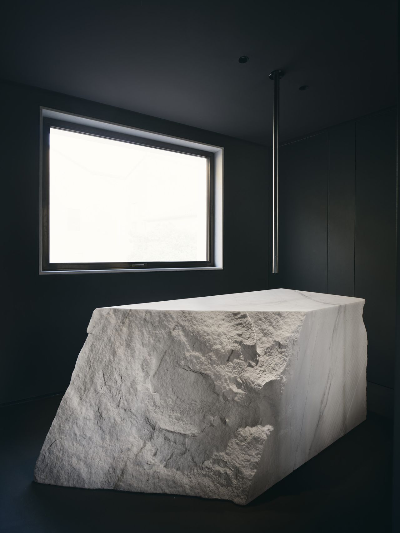 The guest bathroom is dominated by the vast marble sink