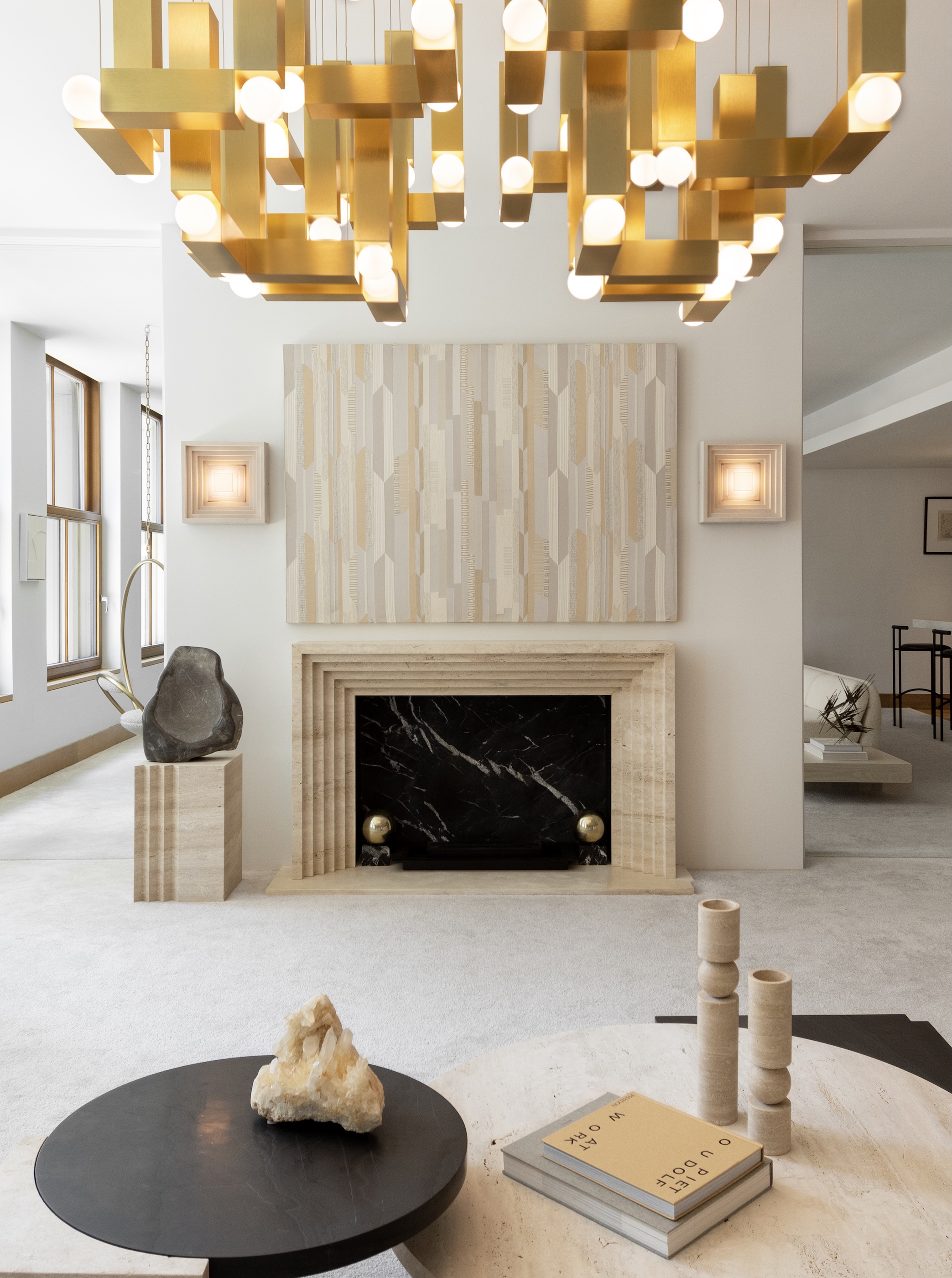A light and modern mantelpiece with symmetrical statement layered lighting