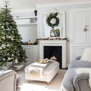 room with sofa set cushion and christmas tree