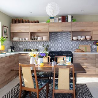 kitchen with kitchen retro style wood slab door units and dining table with chairs from cramped seventies kitchen