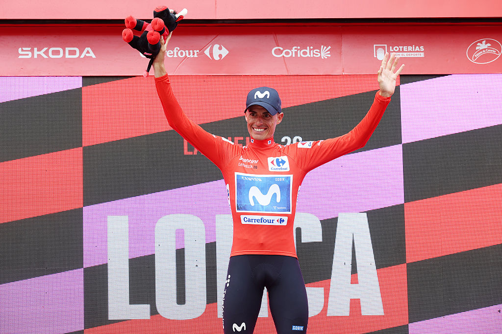 Enric Mas of Spain and Movistar Team celebrates at podium as Red Leader Jersey winner