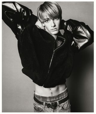 1990s male model posing in bomber jacket and jeans