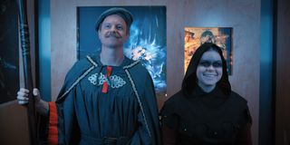 (L to R) David Hornsby as David Brittlesbee and Jessie Ennis as Jo, in an elevator in live action roleplay outfits in Mythic Quest "Everlight"