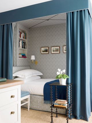 Blue and white bedroom with niche bed