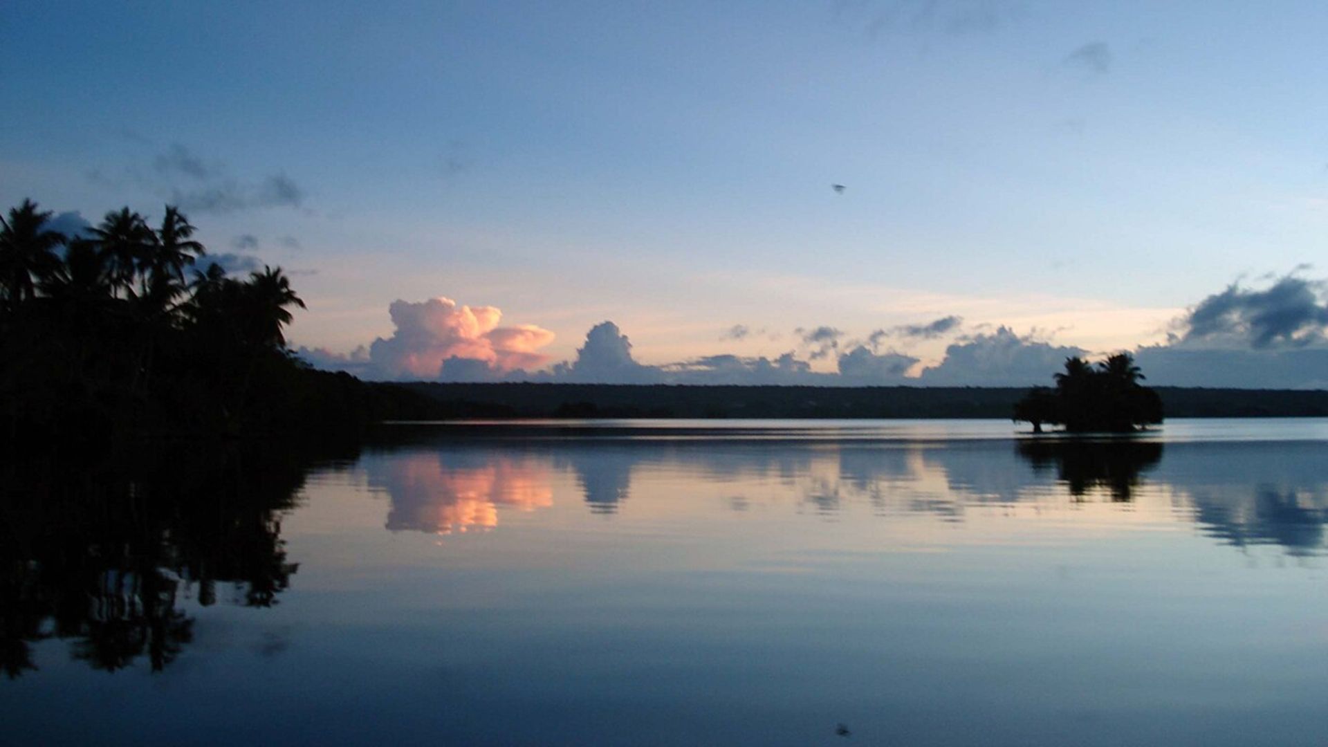 A photo of the sun setting on Lake Tegano