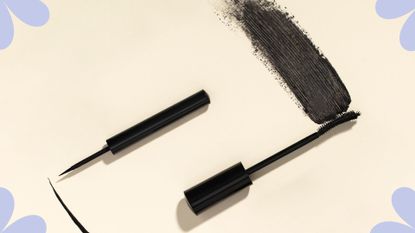 A mascara wand and eyeliner swatching on a yellow backdrop for mascara vs eyeliner